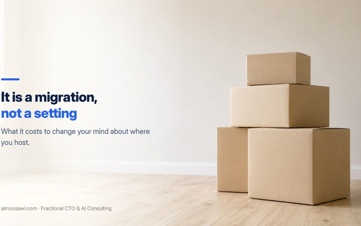 Plain cardboard moving boxes stacked in an empty, brightly lit room with a bare wall and wooden floor